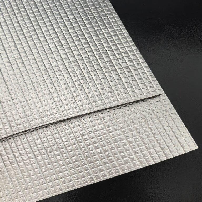 Reflective insulation material with a textured foil surface