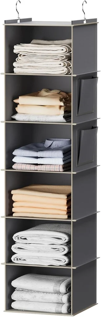 Gray hanging closet shelves holding folded clothing