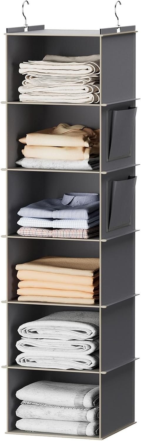Gray hanging closet shelves holding folded clothing